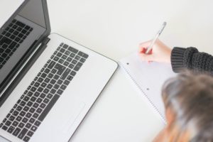 woman writing in notebook